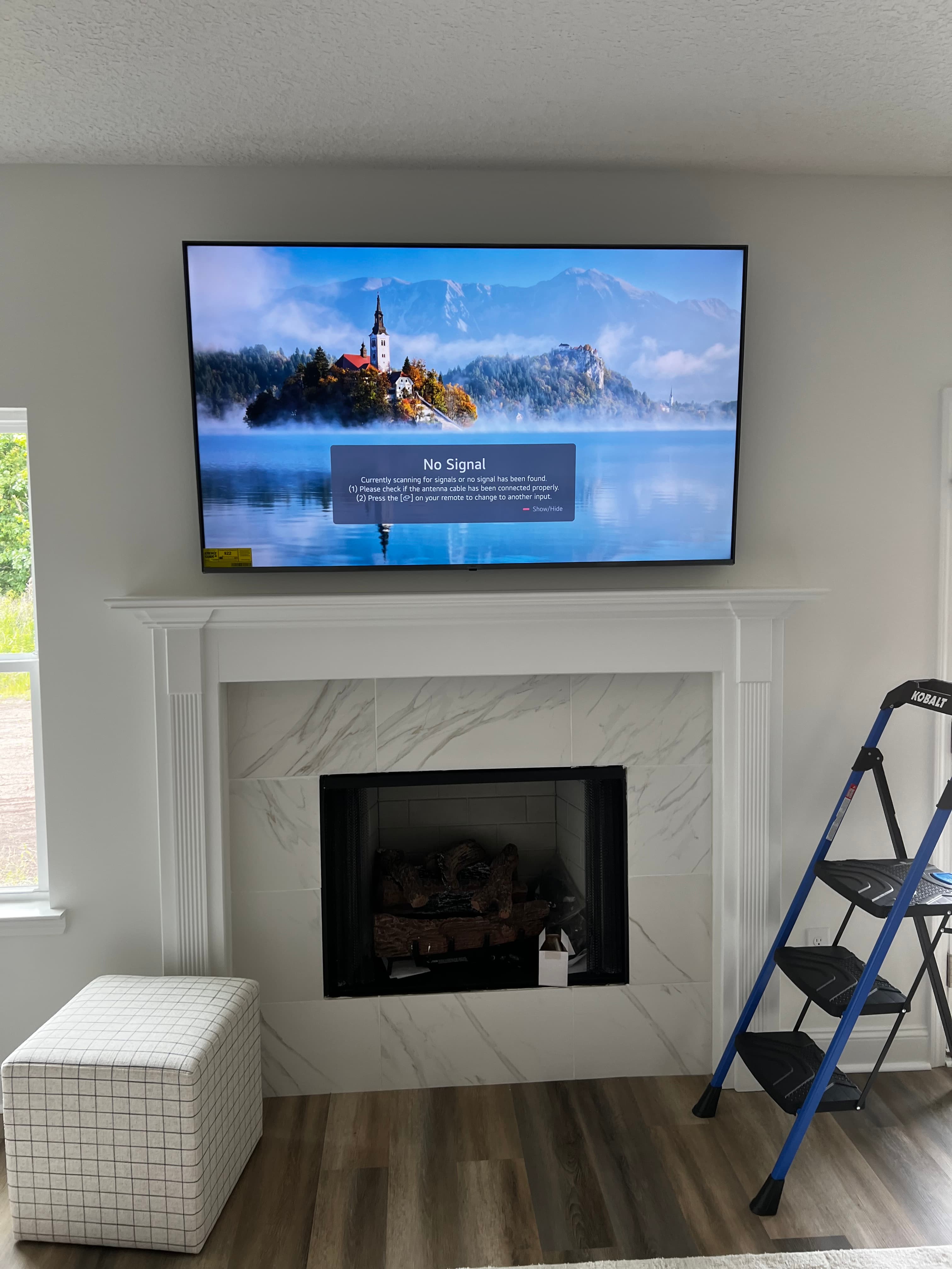 TV mounted securely over a fireplace